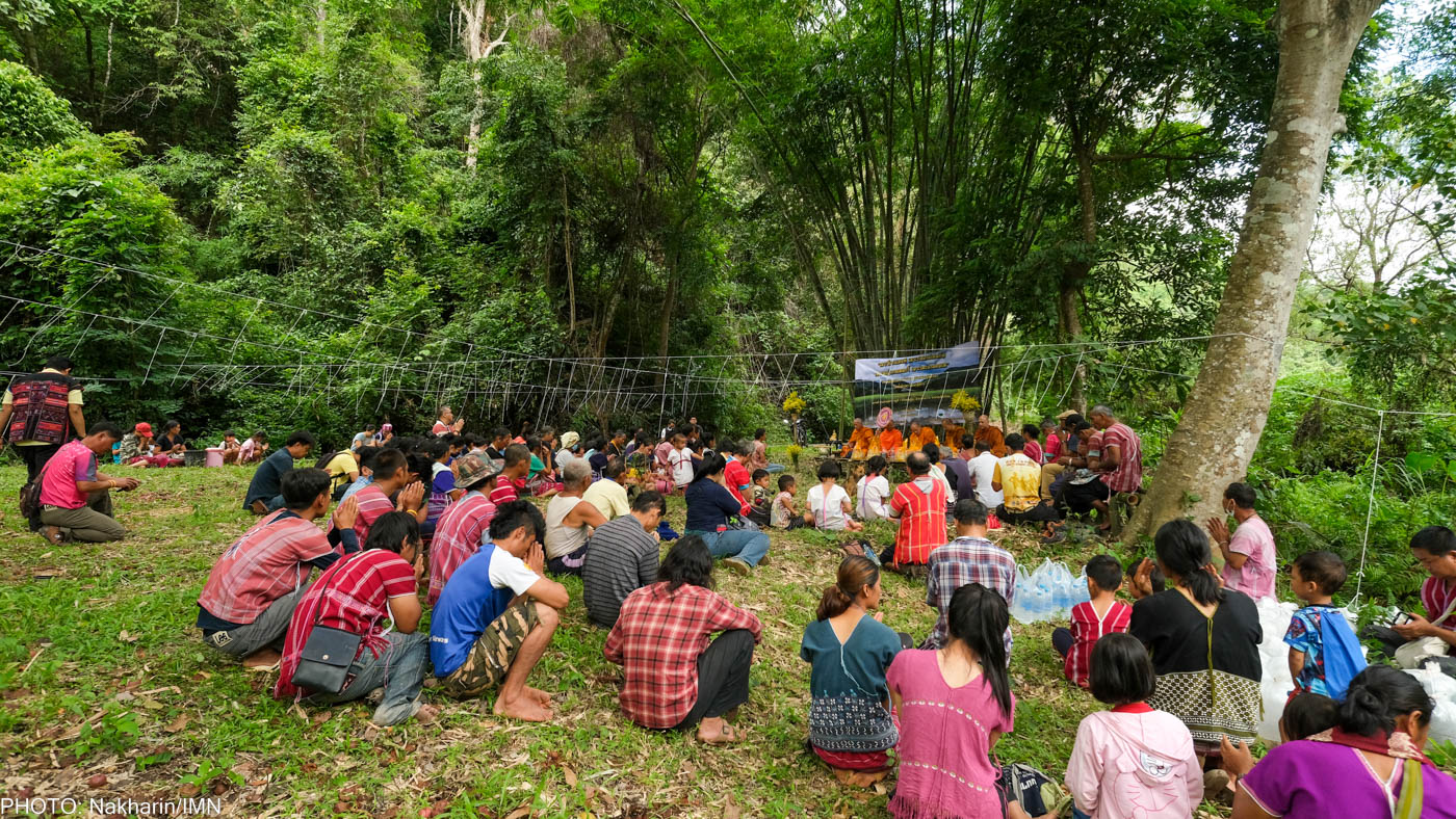 Huay Ee Khang villagers and neighbors from nearby villages in Chiang Mai, Thailand are participating in their traditional ritual to inform the guardian spirits before releasing fish into Mae Wan stream.